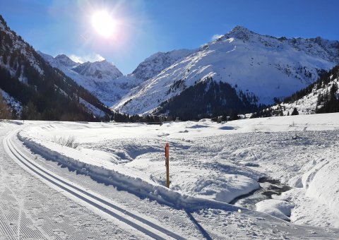 Tiefe Sonne in schneebedeckten Bergen