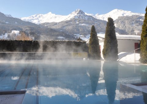 Das Outdoorbecken mit Blick auf die schneebedeckten Berge